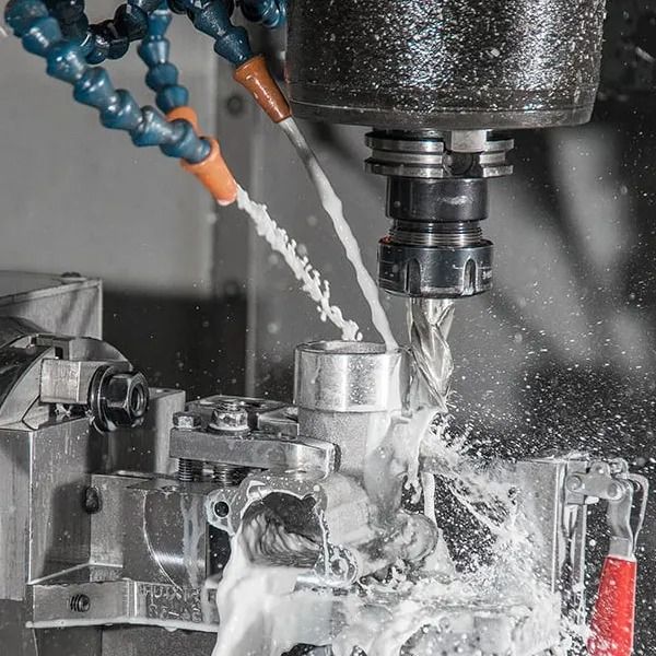 CNC milling operation with flood coolant on an aluminium component